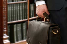 man with briefcase in front of books